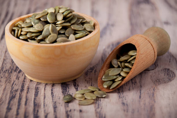 Pumpkin seeds in wooden bowls stock photo