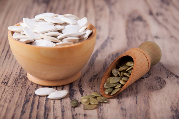 Pumpkin seeds in wooden bowls stock photo