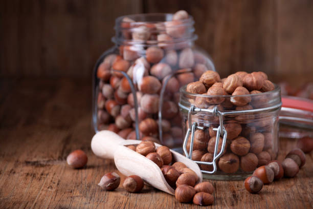 Hazelnuts in a glass jars stock photo