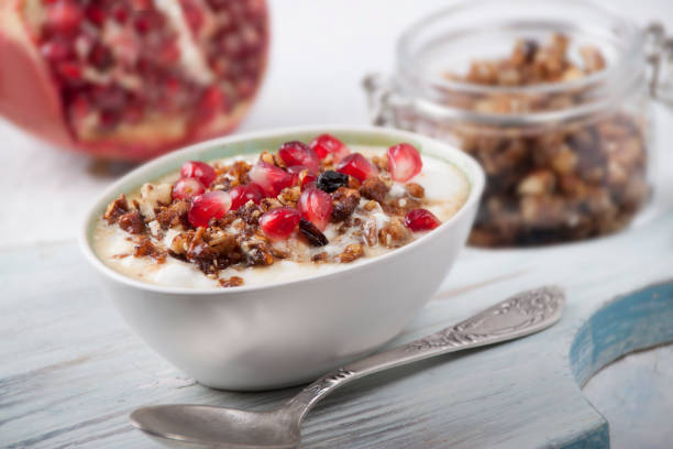 Smoothies with homemade granola and pomegranate stock photo