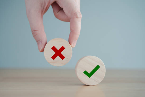 istock Hand pick red wrong or cross icon on wood cube and check mark symbol stand on table for true or false changing mindset or way of adapting to change leader and transform quiz answer and poll concept. 1919014631