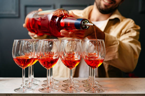 istock Pouring Red Alcohol into Glasses at Social Event 1919024465
