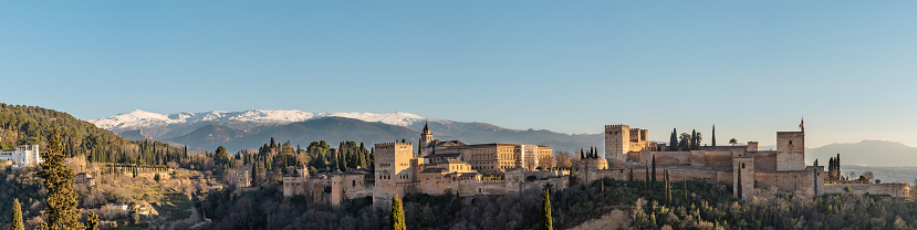 A Panoramic view of the Alhambra in Granada with the Sierra Nevada mountain in the background in Andalucia, Spain.