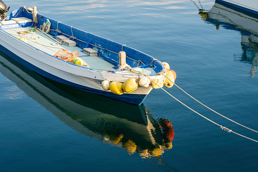 small fishing boat tied to the port