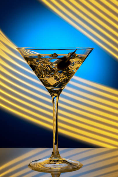 A clear glass filled with a cool refreshing beverage resting atop a bar counter