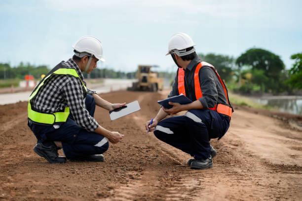 istock Highway engineers discuss plans for construction improvement based on roadworks. Soil Fill, Backfill Compaction for Sub base, Base Course, Surveyor Engineer inspector in highway construction. 1919067296
