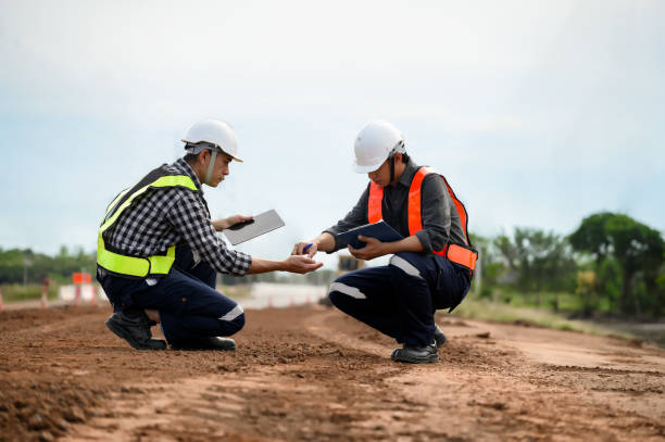 istock Highway engineers touch and inspect laterite soil for construction improvement base road work, Civil Engineer work in the inspector job in highway construction. 1919067297