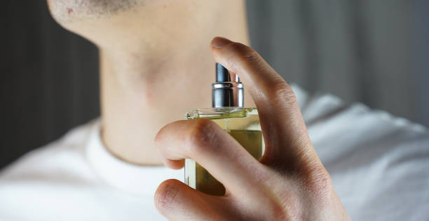 istock Person spraying parfumes on the neck. Man using cologne. 1919076481