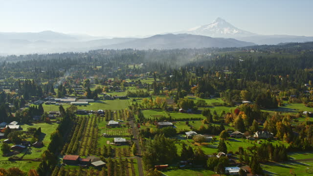 AERIAL Above a beautiful town in Hood River County in Oregon with Mt. Hood in the distance