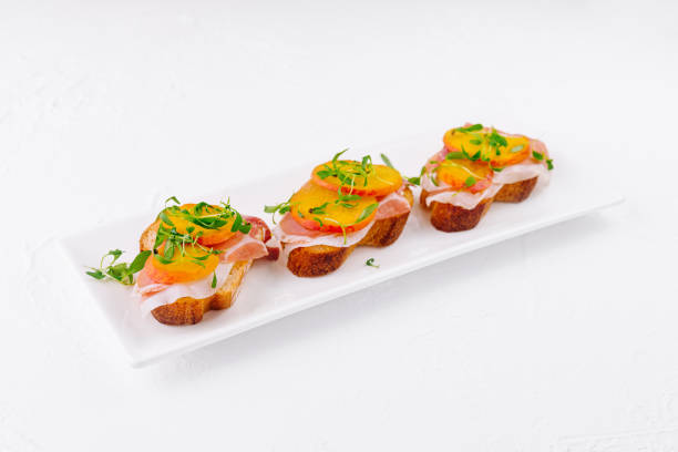 istock bruschetta with prosciutto and pear on white plate 1919083520