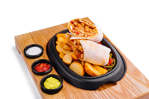 shawarma with fried potato wedges and different sauce