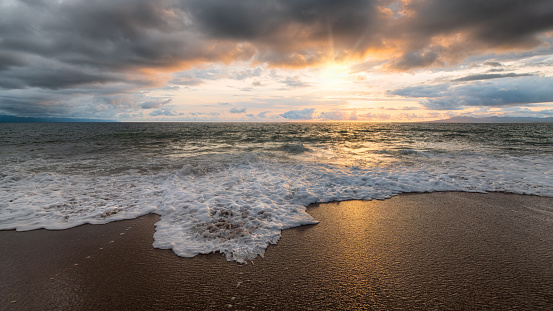 An Ocean Seascape With Golden Sun Rays Breaking Through The Clouds 16:9 High Resolution