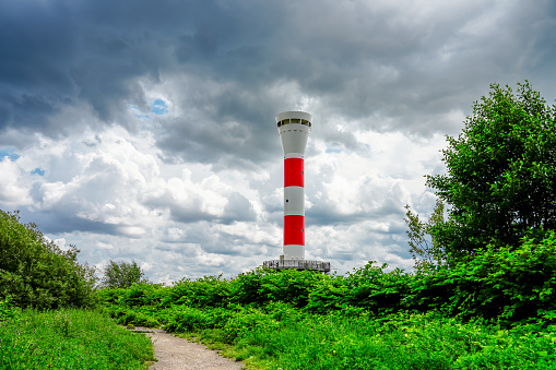 Red and white Blankenese lighthouse near Hamburg. Historic lighthouse on the Elbe at the Muehlenberg marina.