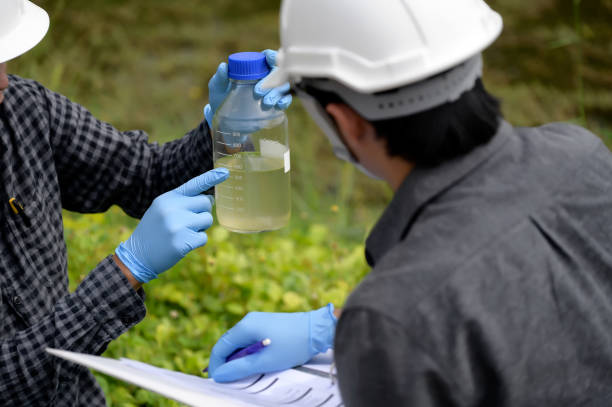 istock Environmental Engineers Inspect Water Quality with Note and Collect water samples in The Field Near Farmland, Fish Ponds, Natural Water Sources that may be Contaminated by Suspicious Pollution Sites. 1919120052