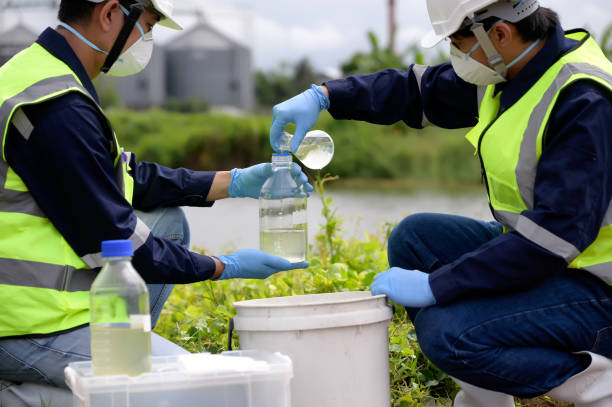 istock Environmental Engineers Team Take Water Samples at Natural Water Sources. Water that smells bad Near Farmland, Fish Ponds May Be Contaminated by Toxic Suspicious Pollution Sites. 1919120059