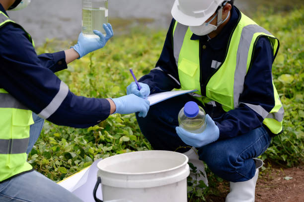 Environmental Engineers Team Take Water Samples at Natural Water Sources. Water that smells bad Near Farmland, Fish Ponds May Be Contaminated by Toxic Suspicious Pollution Sites.