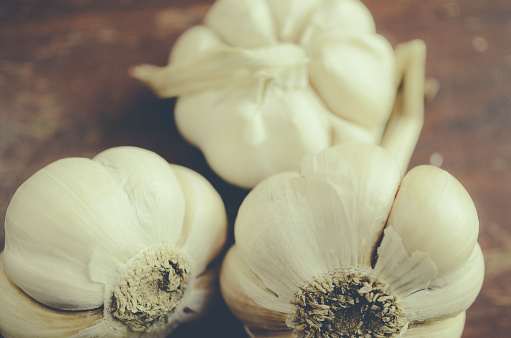 Garlic bulbs and garlic cloves on a mirror. Selective focus.