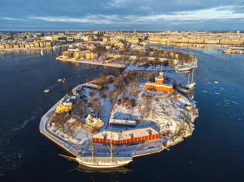 Panoramic view of the islands of Skeppsholmen and Kastellholmen d in Stockholm, Sweden in winter, with snow and ice on the sea. Bright morning light.