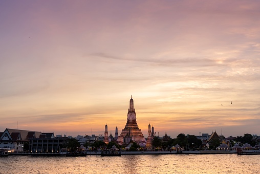Sunset view of Wat Arun with Birds Flying Around