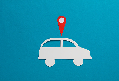 Paper cut car icon with gps navigation point on blue background