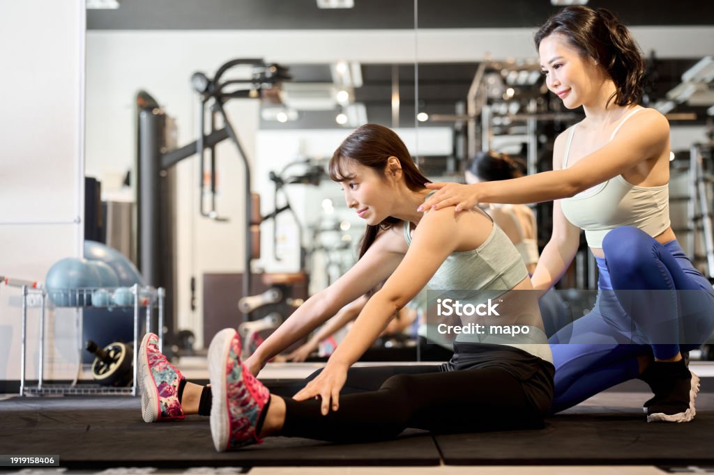 Hamstring Woman Woman Doing Hamstring Stretches With Partner Stock Photo - Download ...