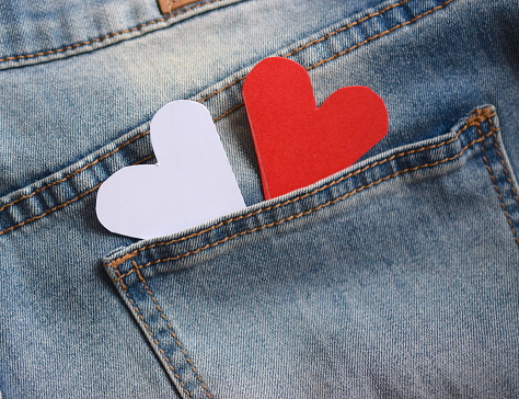 Blue jeans with two paper hearts in pockets.