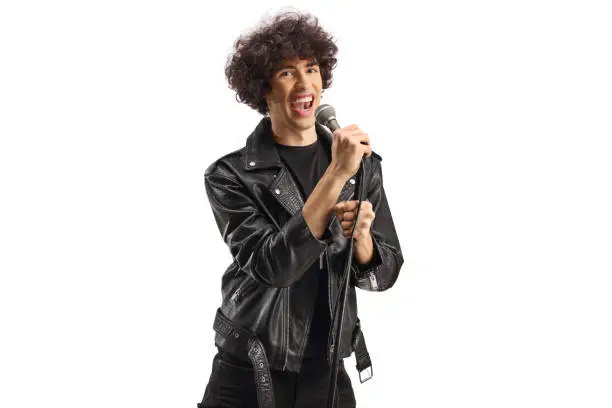 Photo of Young male singer in a leather jacket singing with a microphone