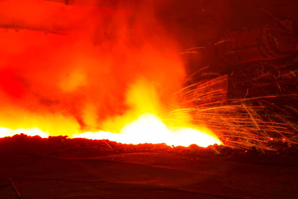 iron works blast furnace taphole spewing molten iron, closeup of photo