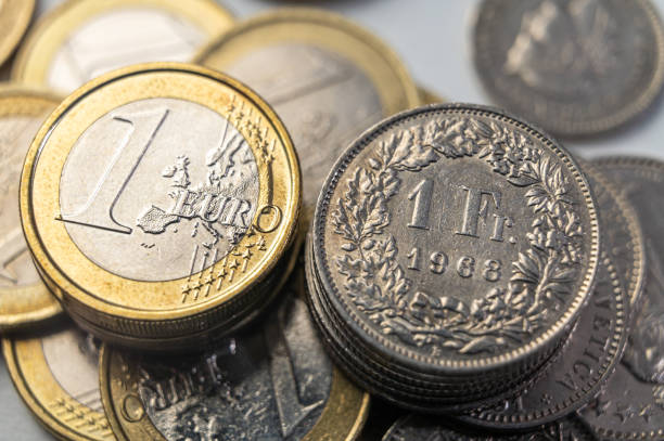 istock Euro and Swiss Franc coins. 1919216142