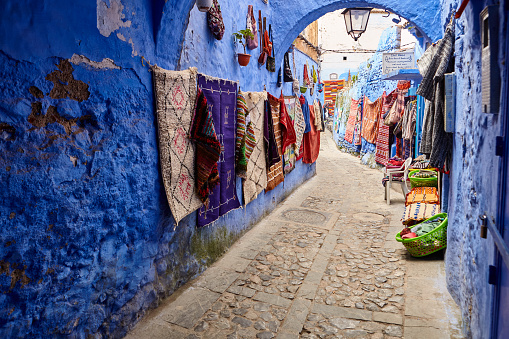 Street with handmade Maroccan rugs in Chefchaouen, Morocco, Africa.