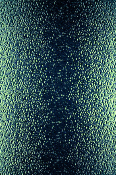 istock Background of dark green relief glass with drops. 1919230367