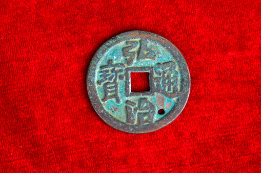 chinaese ancient money on the red background, closeup of photo