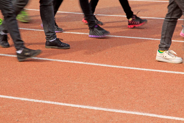 istock Walking man legs on runway in a sports ground 1919240019
