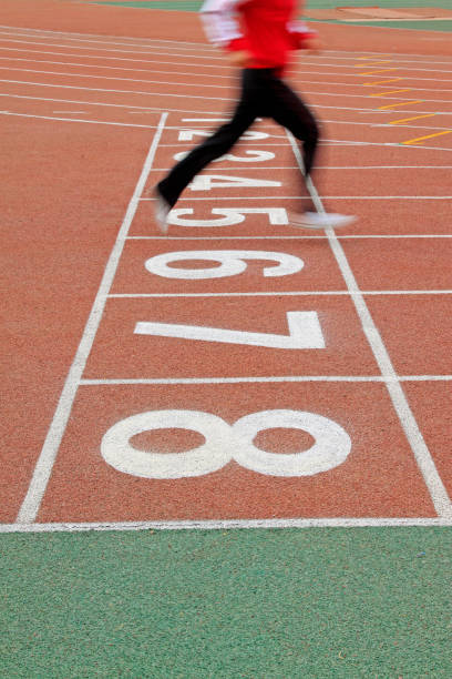 istock Walking man legs on runway in a sports ground 1919240027