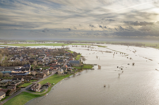 IJssel river with high water level on the floodplains of the river IJssel at the village of Wilsum on the riverbanks of the river after a long period of heavy rain upstream in December 2023.