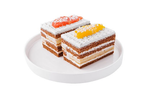 two slices of multilayer cocoa sponge cake with coconut flakes