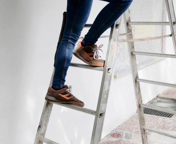 istock Girl in jeans on a ladder 1919246464