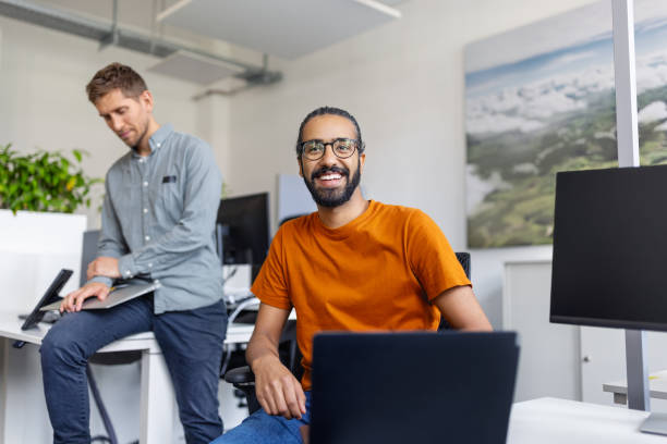 istock Smiling businessman looking at camera at startup office 1919246995