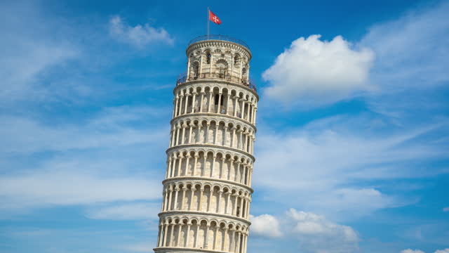 Time lapse of Leaning Tower of Pisa with perfect blue sky and cloud and tourist people walking and sightseeing attraction view point in Pisa, Tuscany, Italy