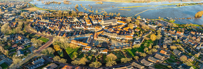 Aerial view on Hattem on the banks of the river IJssel with high water level on the floodplains in the Hoenwaard near Hattem on the riverbanks of the river after a long period of heavy rain upstream in January 2024.