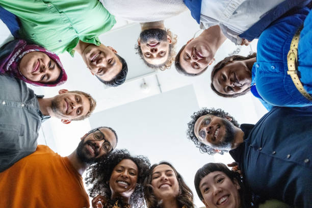 istock Smiling multiethnic business people huddling together in office 1919250763