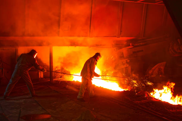 iron works blast furnace taphole spewing molten iron