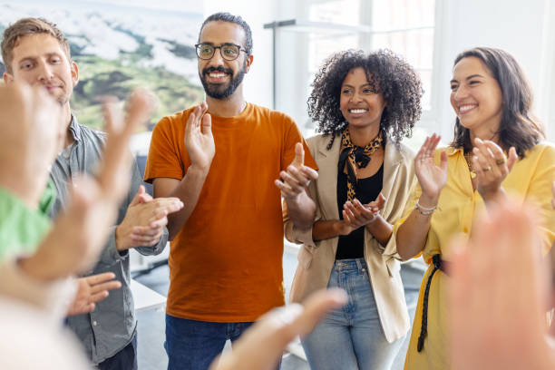 istock Multi-ethnic group of business people cheering in huddle 1919252417