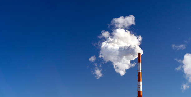istock Factory chimneys emit water vapor. Concept air pollution, environmental problems, air emissions. Banner copy space 1919254557