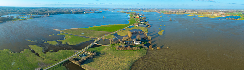 IJssel river with high water level on the floodplains of the river IJssel in the Hoenwaard near Hattem on the riverbanks of the river after a long period of heavy rain upstream in January 2024.