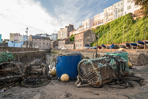 Fishing equipment on a quay side, in a traditional British fishing village. The location is Tenby, on the southern coastline of Wales