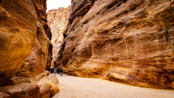 istock Group of tourists in path in Petra 1919270391