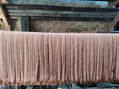 threads that have just been dyed are being dried in the sun
