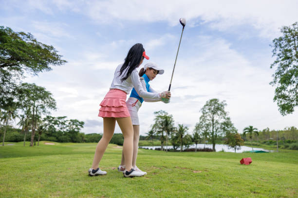 istock coachs are teaching and training female golfers in golf courses, 1919275874
