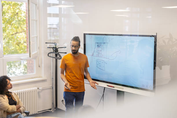 istock Young businessman explaining a project plan to a teammates in meeting room 1919281277